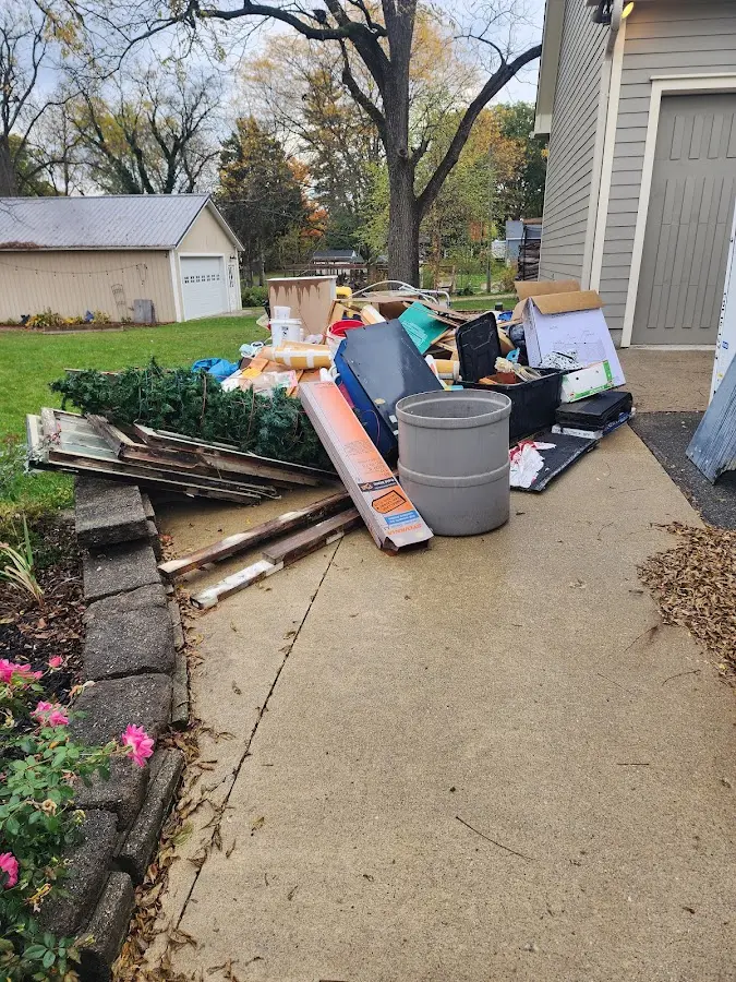 Dumpster being loaded with debris for Roofing Dumpster Rental in Rochester